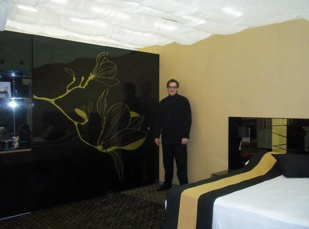 A large gold line drawing forms a feature in a designer hotel space.